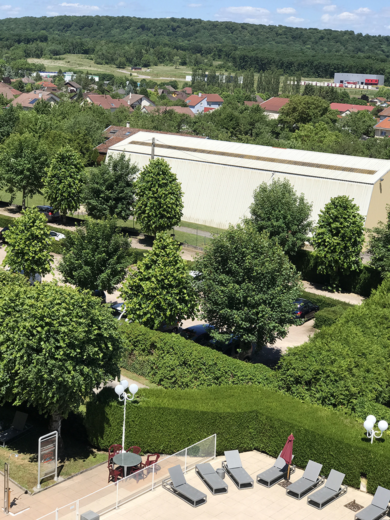 View from the attic window (white structure is a covered tennis court), Hôtel-Club Cosmos Contrexéville
